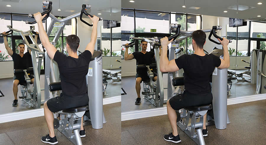 machine lat pulldown performed by male personal trainer